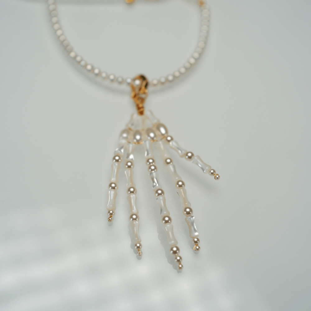 Lunather™ Poseable Pearl Skeleton Hand Necklace